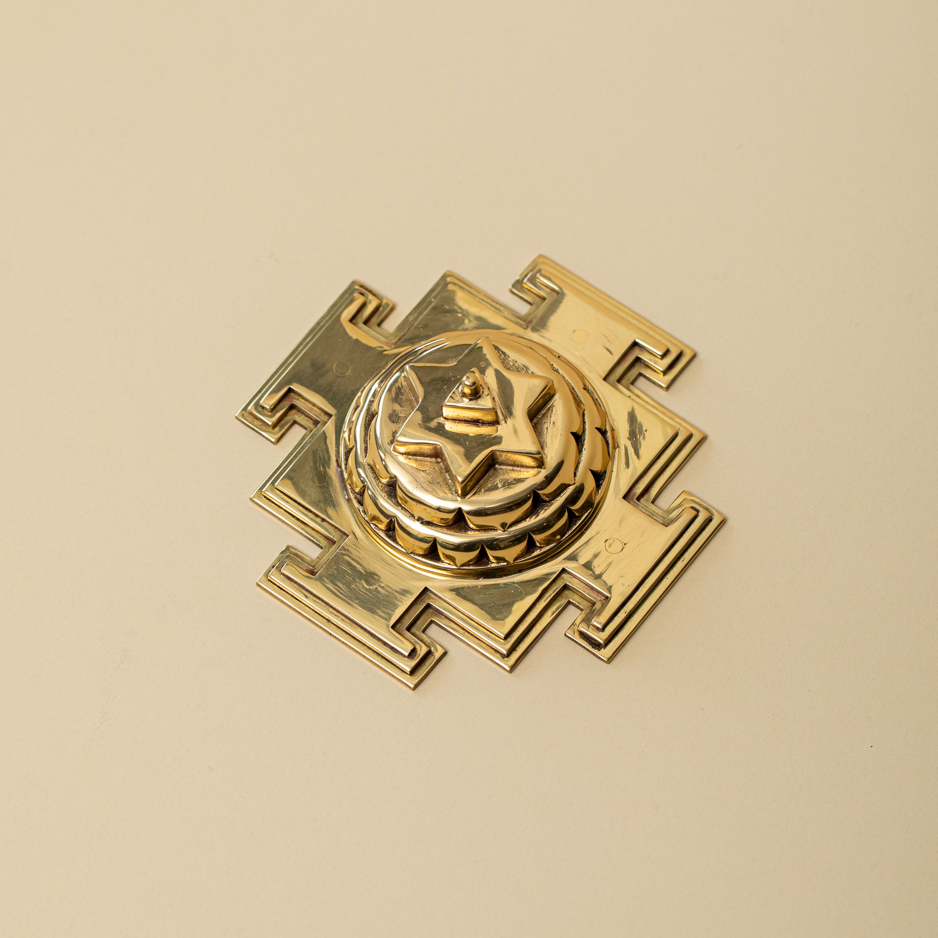 Close-up of energized Baglamukhi Yantra geometric carvings in Panchdhatu